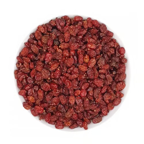 Bowl of dried barberries, authentic Middle Eastern spice, on white background