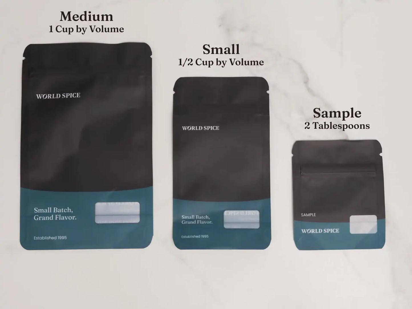 World Spice small batch spice pouches in medium, small, and sample sizes on marble background