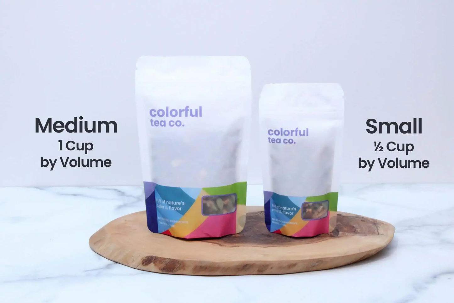 Colorful Tea Co. medium and small tea pouches on wooden board, natural flavor blends