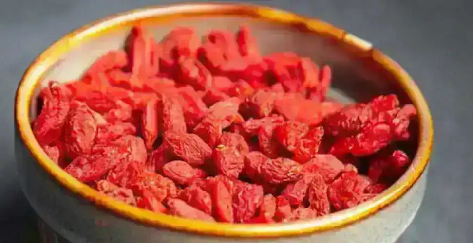 Dried goji berries in a ceramic bowl, vibrant red Middle Eastern superfood