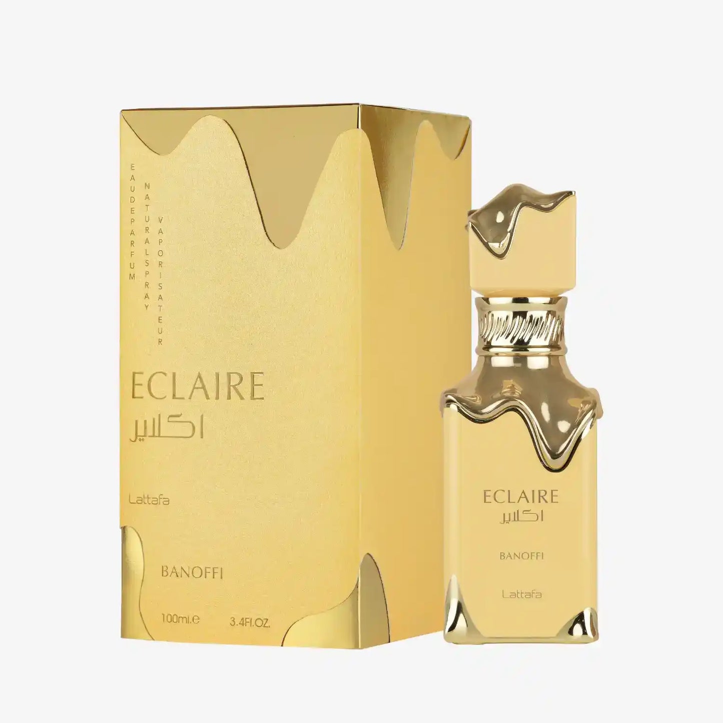 Lattafa Eclaire Banoffi perfume bottle and gold packaging with flowing design accents