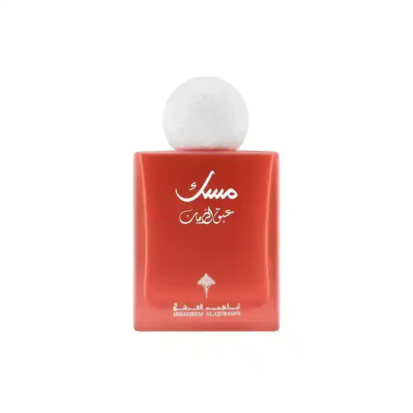 Red bottle of Musc perfume with white cap, Arabic script, and Ibrahim Al Qurashi branding, Middle Eastern fragrance.