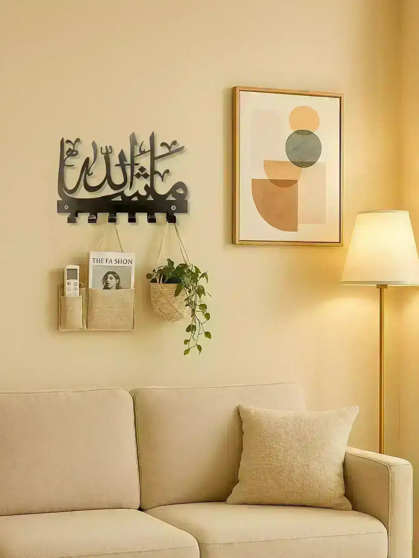 Modern living room with beige sofa, Arabic wall art, abstract painting, floor lamp, and plant decor