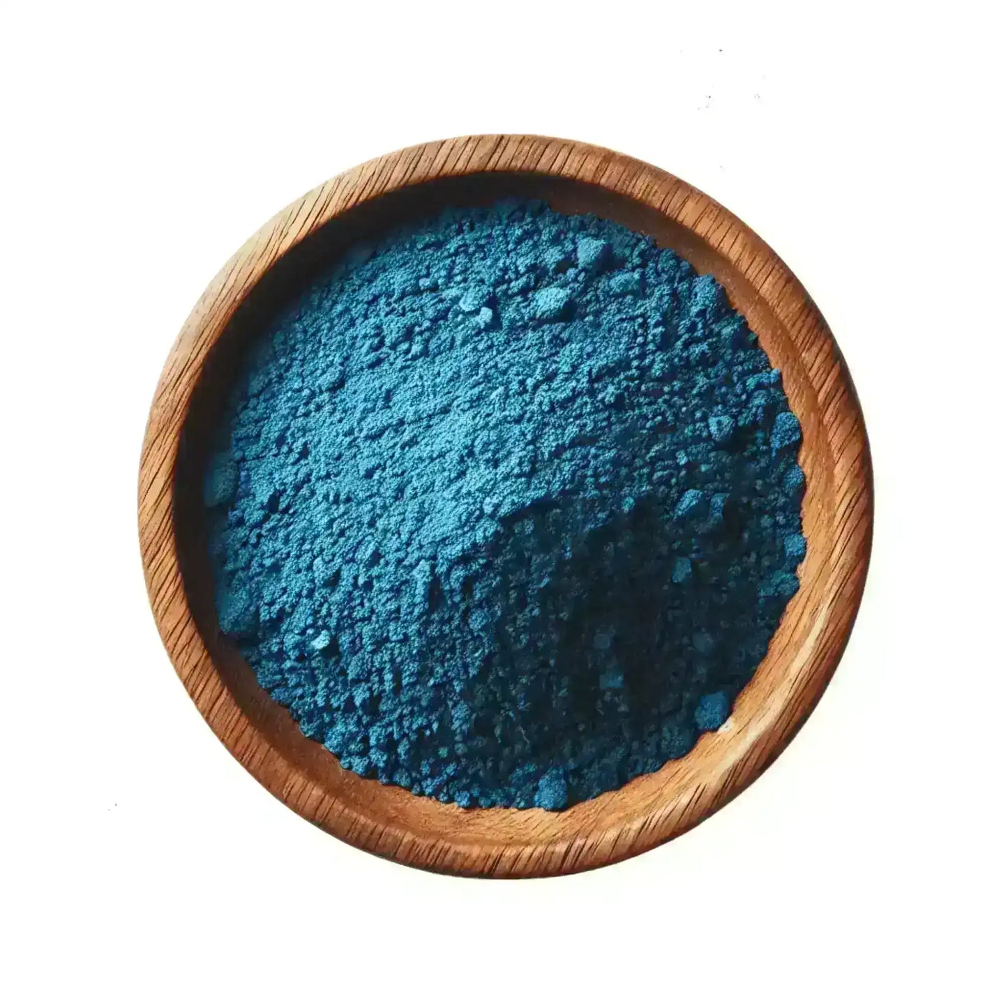 Moroccan nila powder in a wooden bowl, vibrant blue natural skin care ingredient
