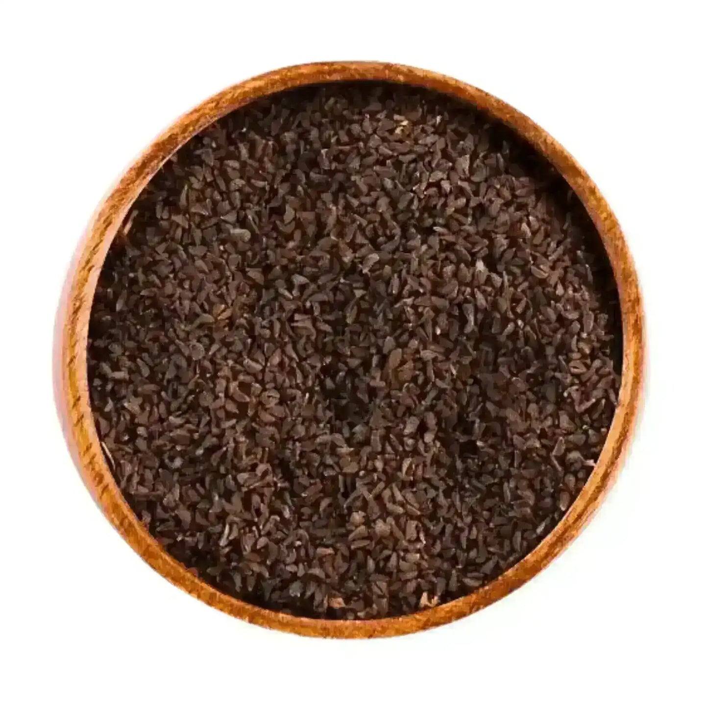 Natural organic harmala seeds in a wooden bowl on white background