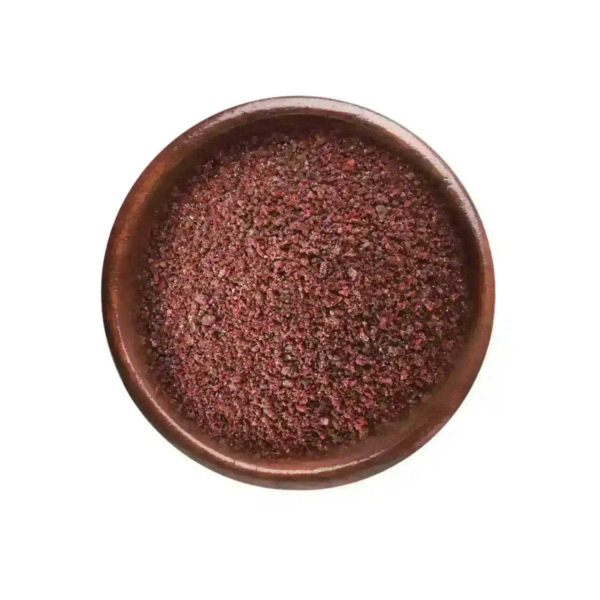 Ground sumac spice in a wooden bowl on a white background