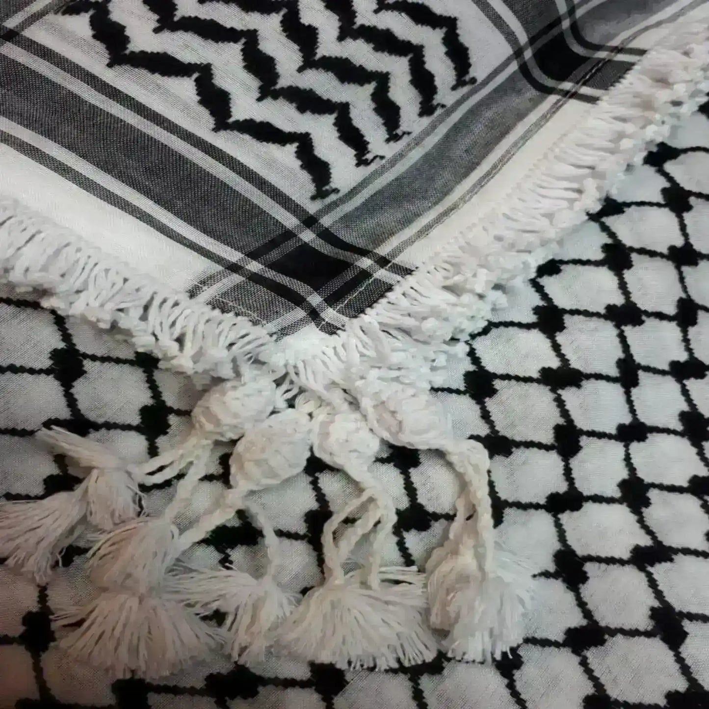 White fringed shemagh with traditional black geometric and zigzag patterns, Middle Eastern scarf.