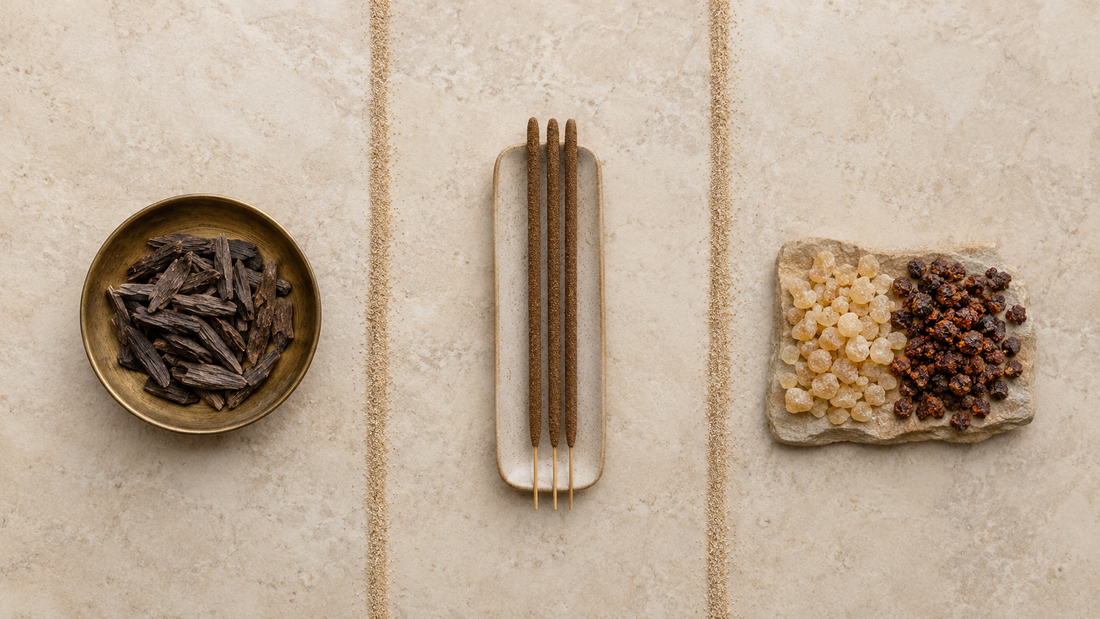 Three-way comparison of bakhoor wood chips, unlit incense sticks and frankincense and myrrh resins on warm stone
