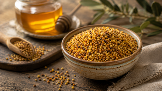 A bowl of multicoloured bee pollen granules with a honey jar on a wooden surface.