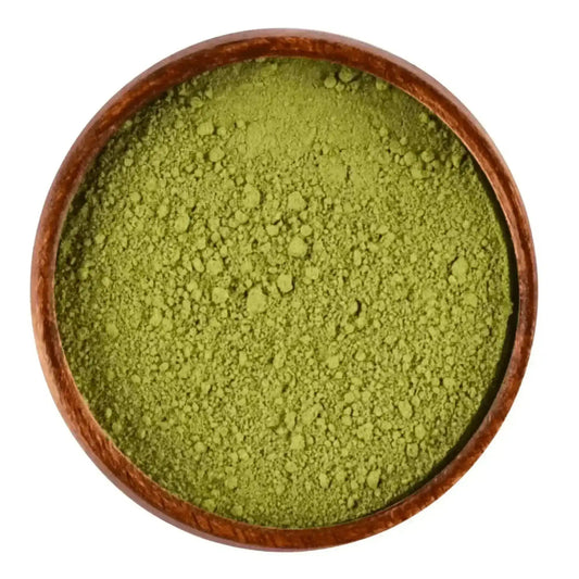 Green sidr powder in a wooden bowl for hair and skin care on white background