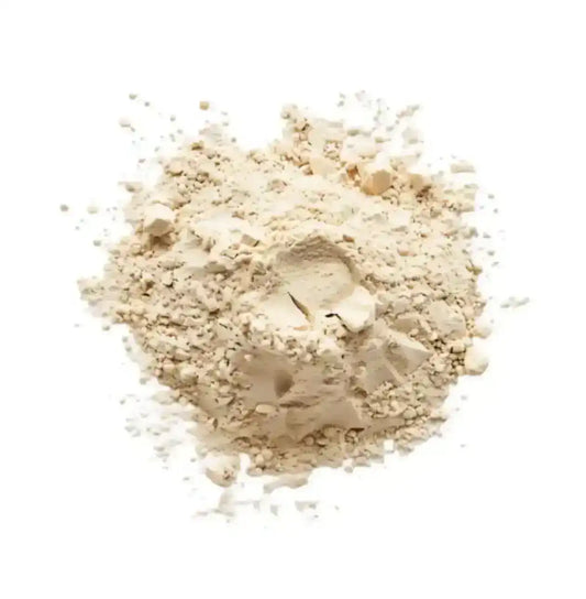 Close-up of light beige nutritional or protein powder on white background