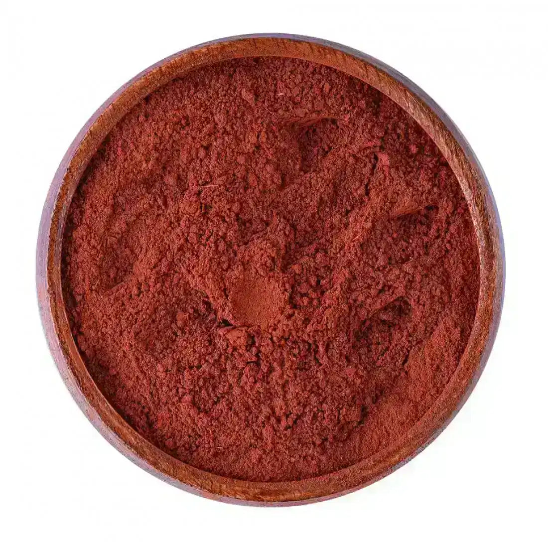 Wooden bowl filled with ground red Middle Eastern spice powder on white background