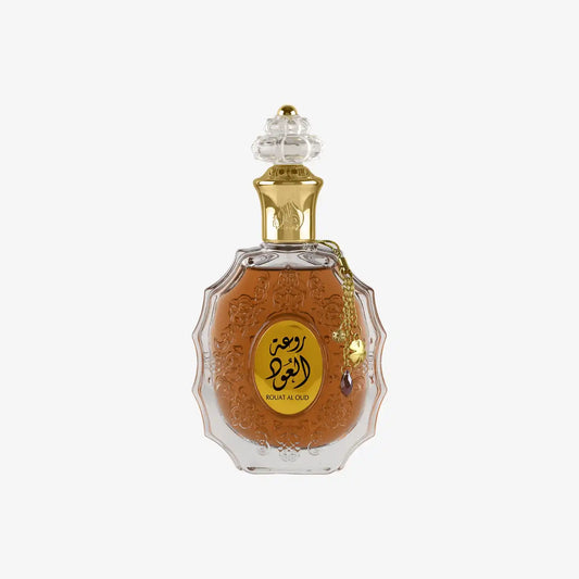 Middle Eastern oud perfume in ornate glass bottle with gold Arabic label and decorative cap