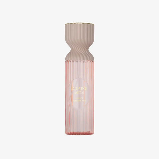 Elegant pink perfume mist bottle with gold text and ribbed design on white background