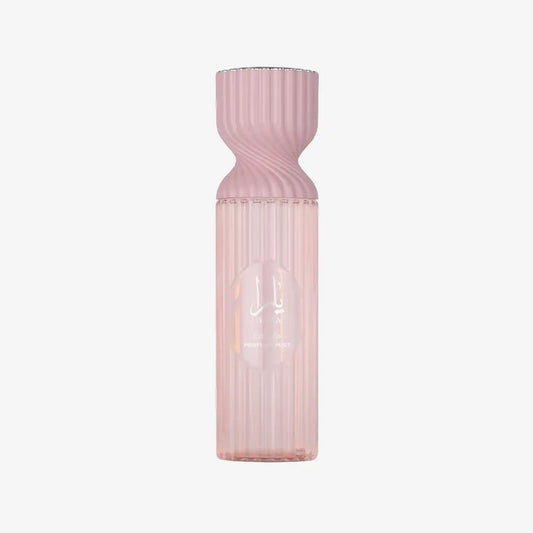 Elegant pink Middle Eastern perfume mist bottle with ribbed glass and Arabic script.