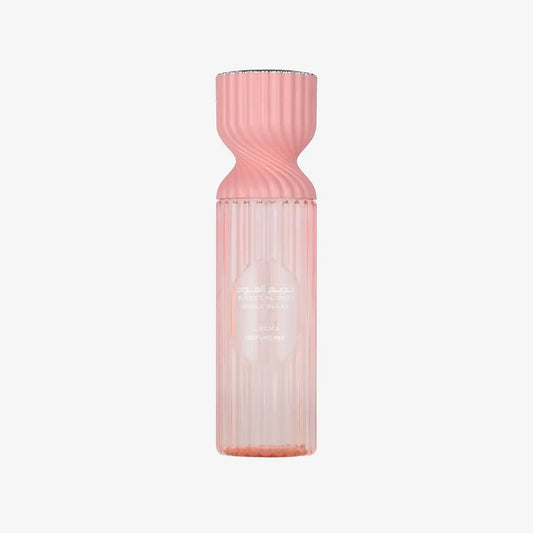 Elegant pink Middle Eastern perfume mist bottle with ribbed design on white background