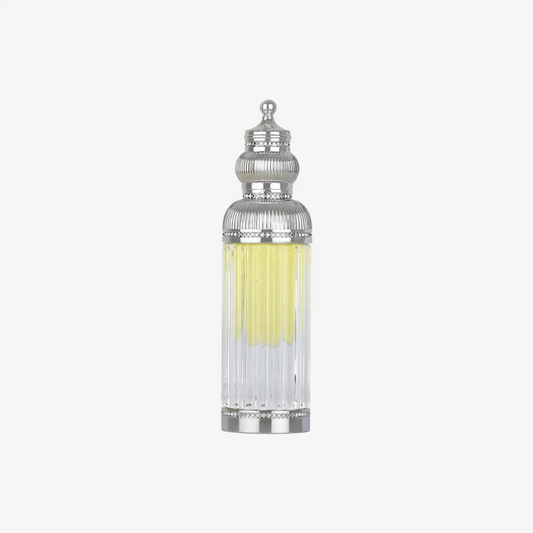 Ornate glass bottle of Middle Eastern oil with silver decorative cap on white background