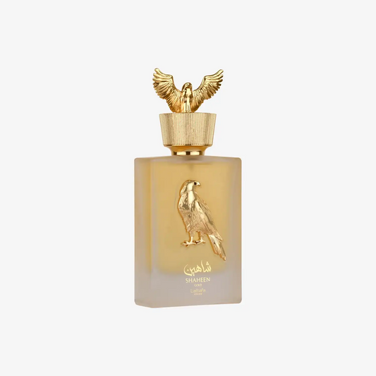 Middle Eastern perfume bottle with gold falcon emblem and Arabic script on frosted glass