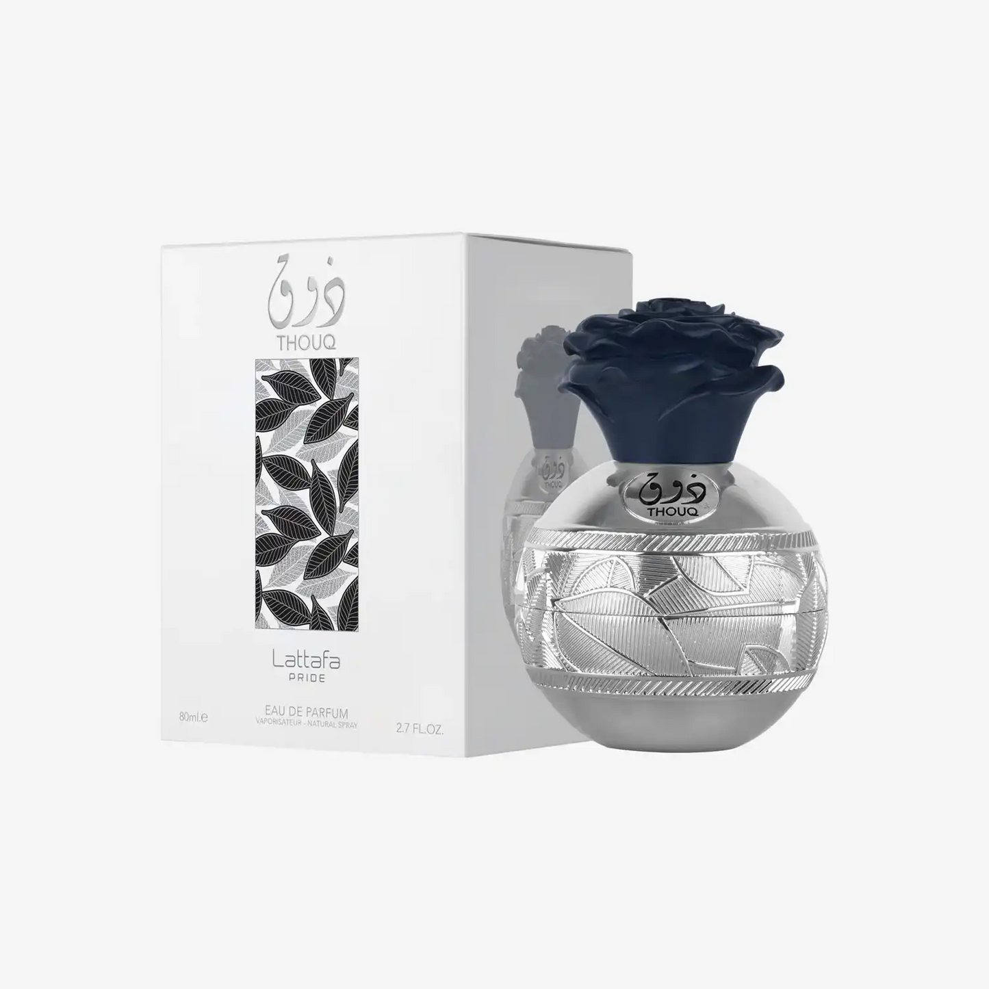 Silver Latafa Pride Thouq perfume bottle with floral cap beside decorative box
