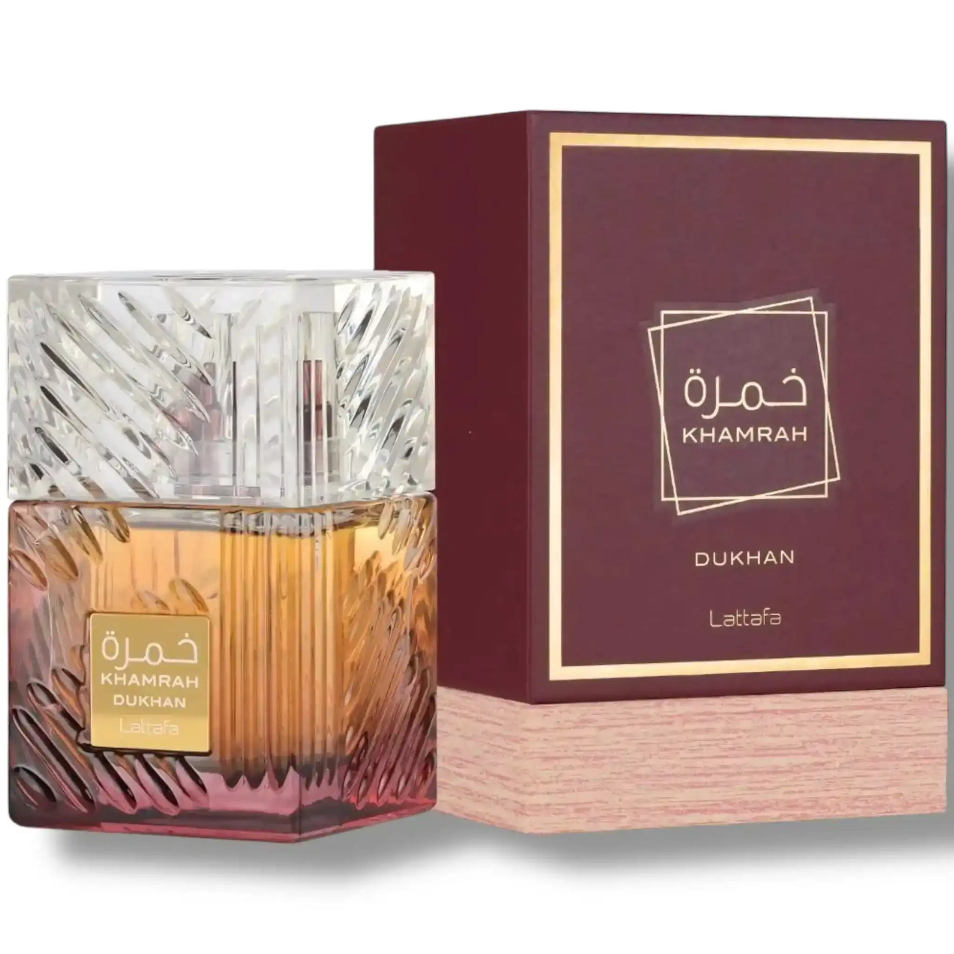 Khamrah Dukhan Lattafa perfume bottle with amber liquid and purple gold-trimmed box