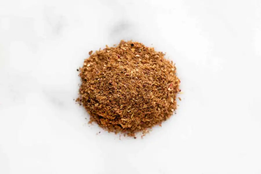 Authentic Middle Eastern spice blend with rich, earthy tones on a marble surface