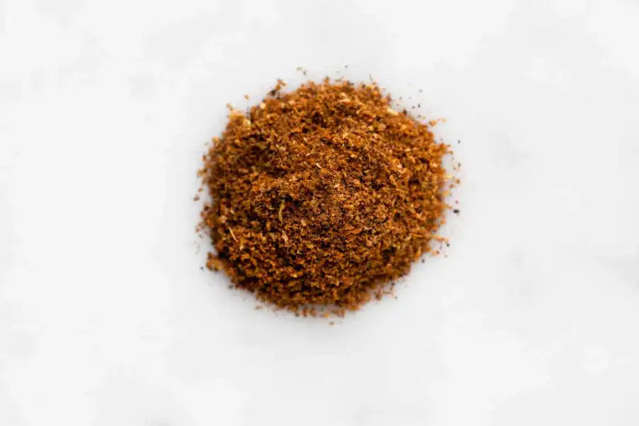 Ground Middle Eastern spice blend on white background