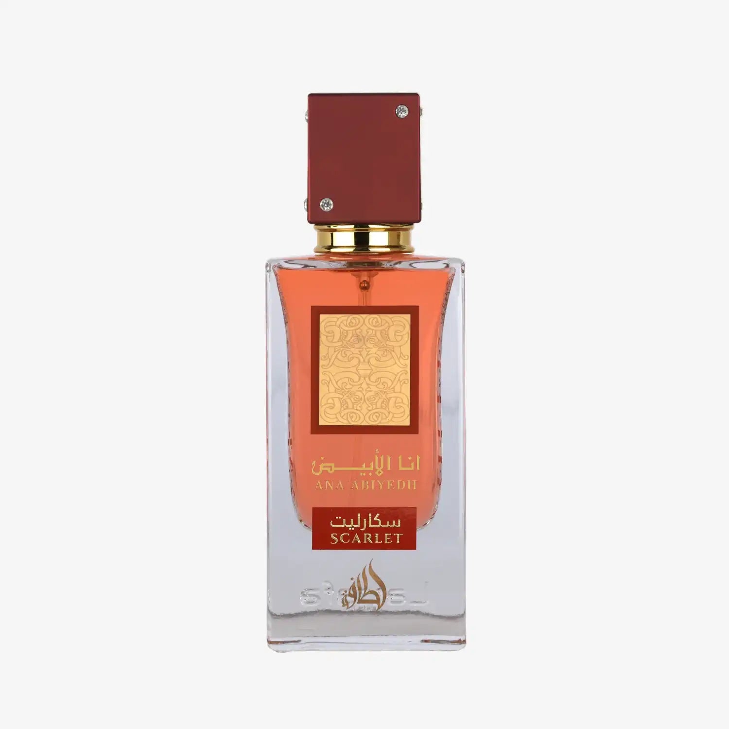 Clear glass perfume bottle with red cap, gold label, and scarlet Arabic and English text.