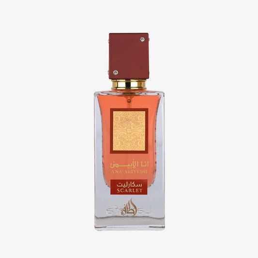 Clear glass perfume bottle with red cap, gold label, and scarlet Arabic and English text.