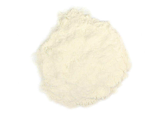 Fine white Arabic gum powder on a plain white background, natural Middle Eastern ingredient