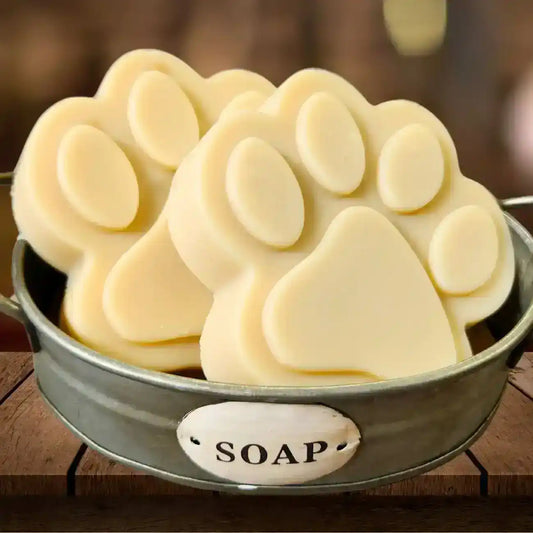 Paw-shaped soap bars in rustic metal container labeled SOAP