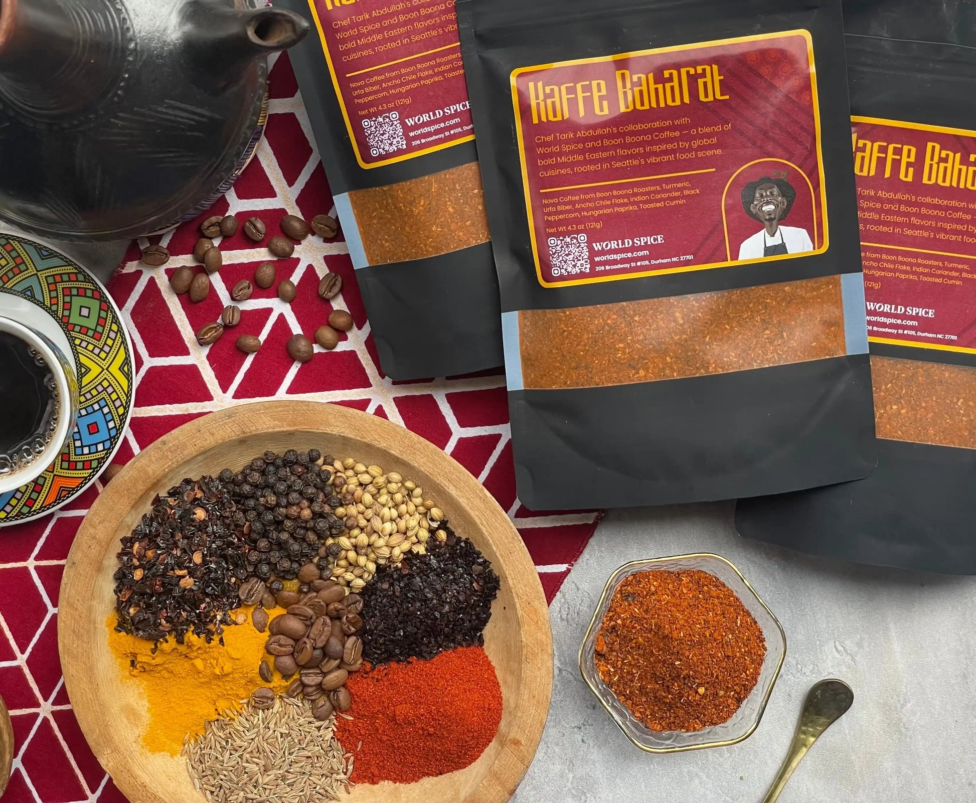 Kaffe Baharat spice blend with coffee beans, turmeric, cumin, paprika, and whole spices on patterned cloth