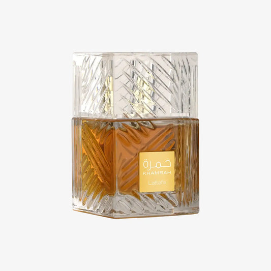 Khamrah Lattafa perfume in a clear, textured glass bottle with amber liquid on white background