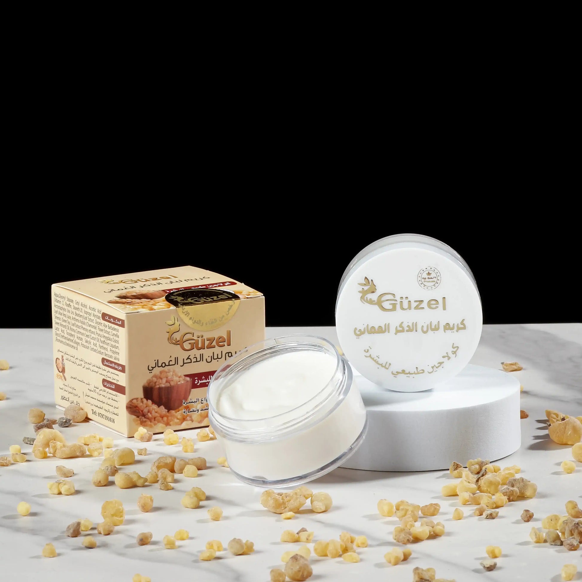Omani frankincense cream jar and box with frankincense resin on marble surface