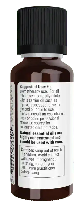 Brown glass bottle of spearmint essential oil with safety and usage instructions on the label