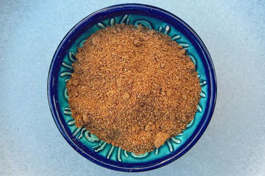 Middle Eastern spice blend in a blue ceramic bowl, perfect for authentic cuisine