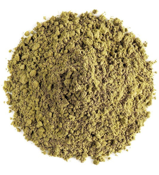 Loose pile of natural green henna powder on white background, Middle Eastern herb