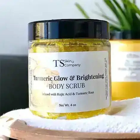 Turmeric body scrub jar with brightening and glow label on a towel, natural skincare product