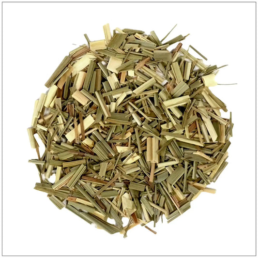Close-up of dried lemongrass herb cut into small pieces on white background