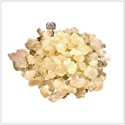 Close-up of translucent golden mastic gum resin pieces isolated on white background