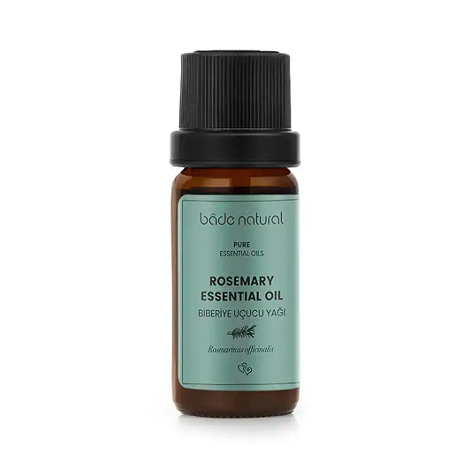 Pure rosemary essential oil in amber glass bottle with black cap, labeled bâde natural