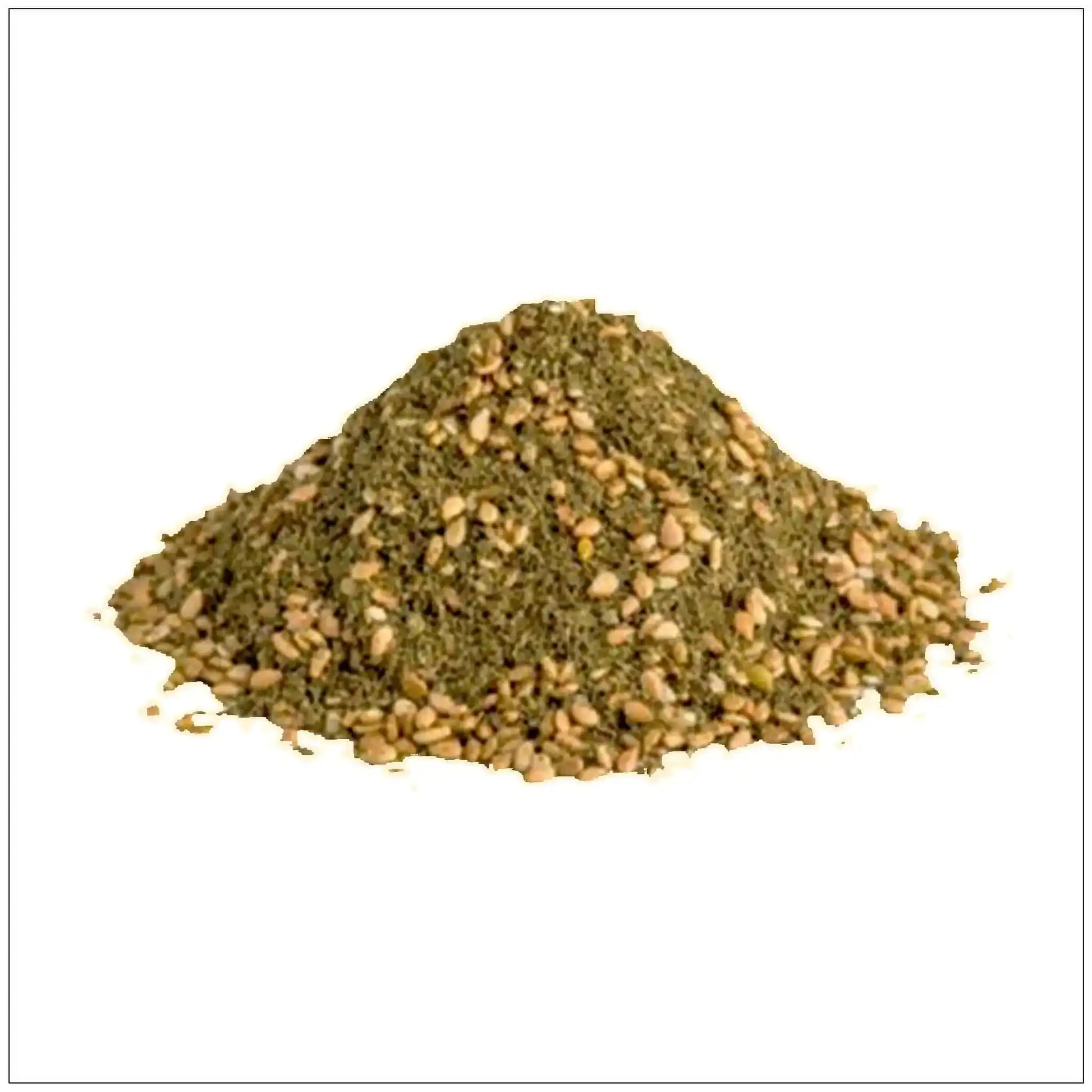 Pile of zaatar spice blend with visible sesame seeds on white background